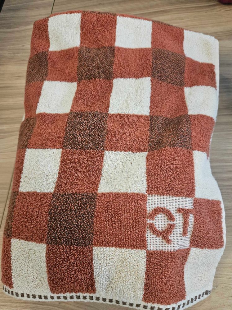 Bath towel with brown checkered design.