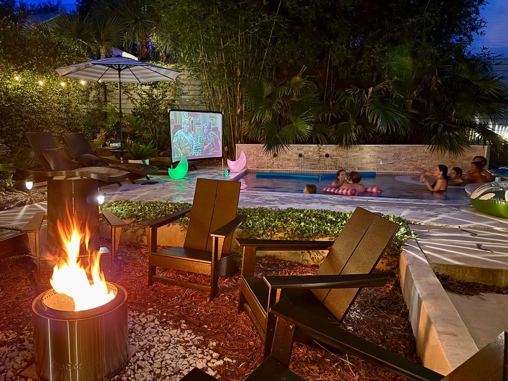 Backyard Pool Area With Firepit And Outdoor Movie Screen