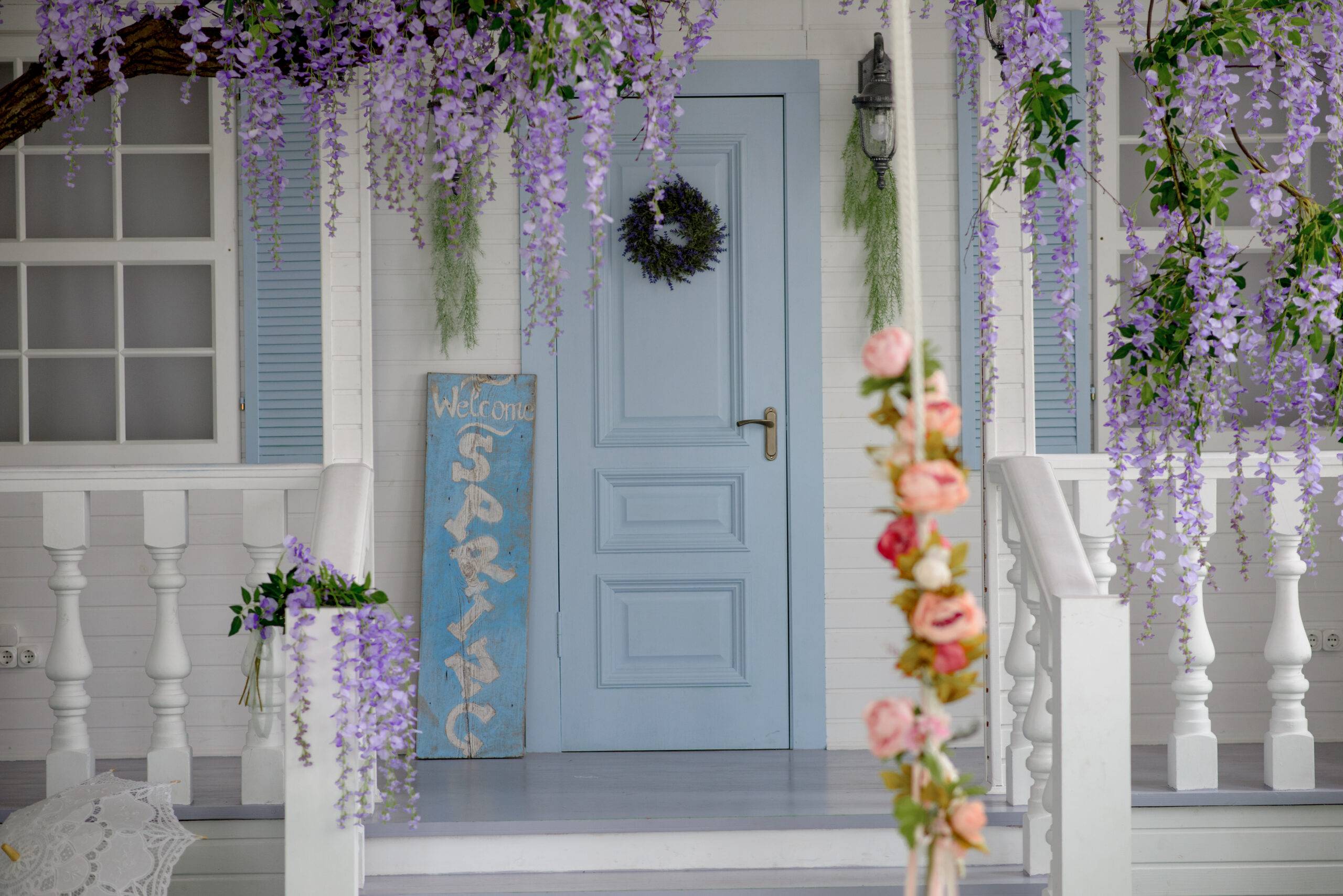 House facade with blue door, porch, staircase and courtyard
