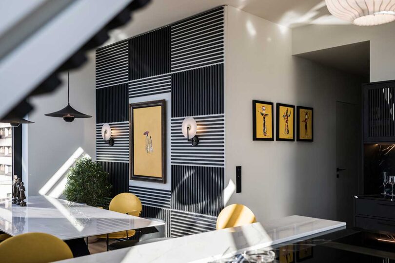 angled view in modern apartment of feature wall with black alternating slacks